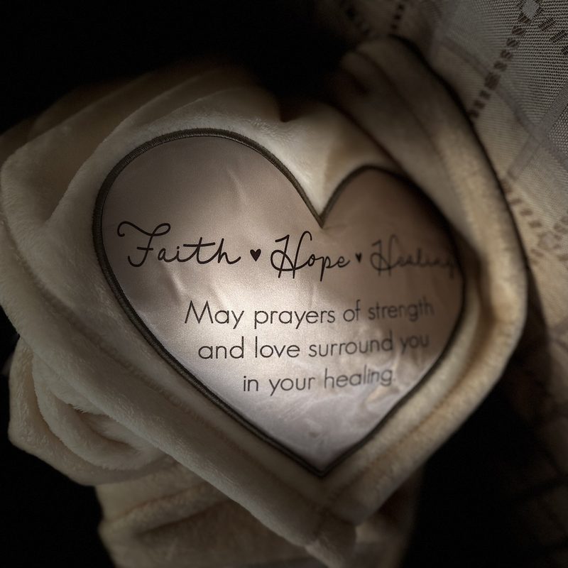 The embroidered heart on a Baskets of Healing blanket: Faith, Hope, Healing. May prayers of strength and love surround you in your healing.